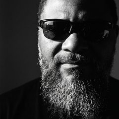 Cedrick Reese, a bearded man in sunglasses, in a black and white portrait